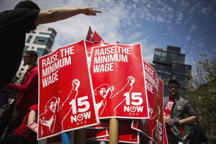 Demonstrators prepare signs supporting the raising of the federal minimum wage during May Day demonstrations in New York May 1, 2014. REUTERS/Lucas Jackson (UNITED STATES - Tags: CIVIL UNREST POLITICS BUSINESS EMPLOYMENT TPX IMAGES OF THE DAY)