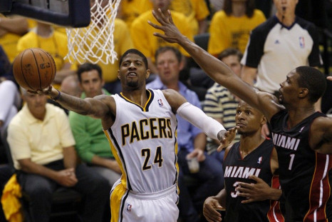 May 28, 2014; Indianapolis, IN, USA; Indiana Pacers forward Paul George (24) goes up for a shot past Miami Heat center Chris Bosh (1) during the second quarter in game five of the Eastern Conference Finals of the 2014 NBA Playoffs at Bankers Life Fieldhou
