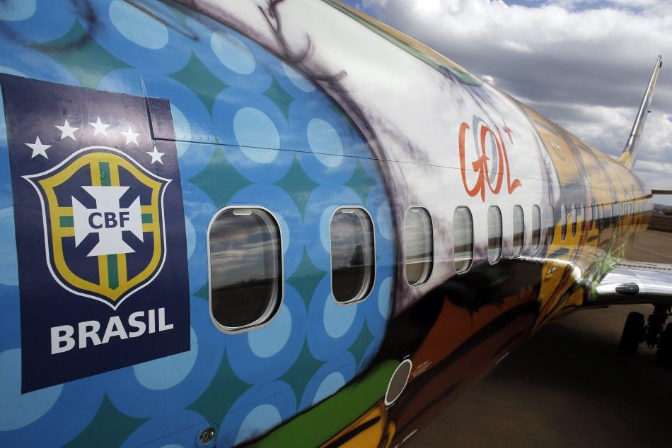 A journalist smiles inside the Boeing 737 aircraft of Brazilian airline Gol, 