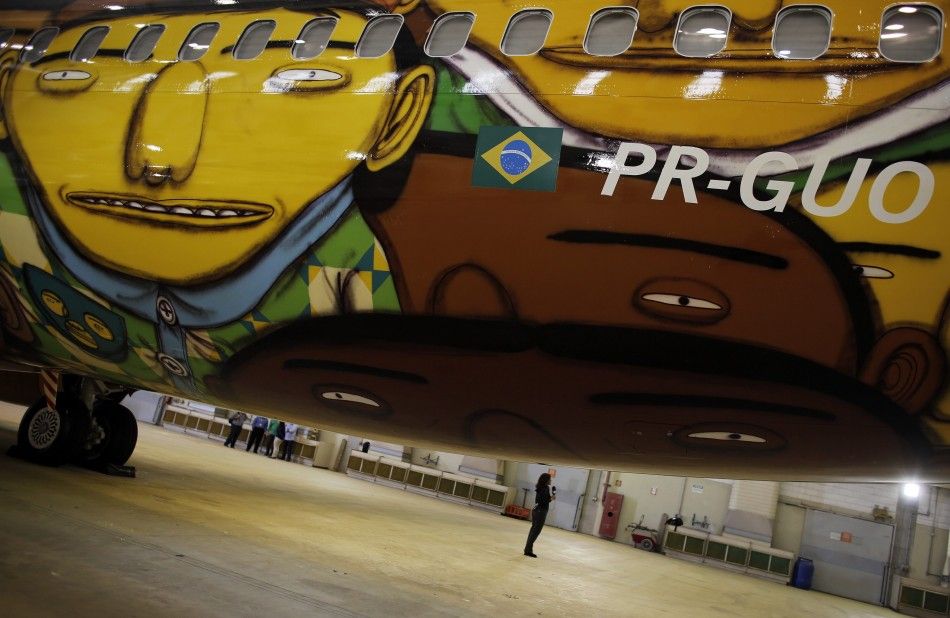 A journalist talks next to the Boeing 737 aircraft of Brazilian airline Gol