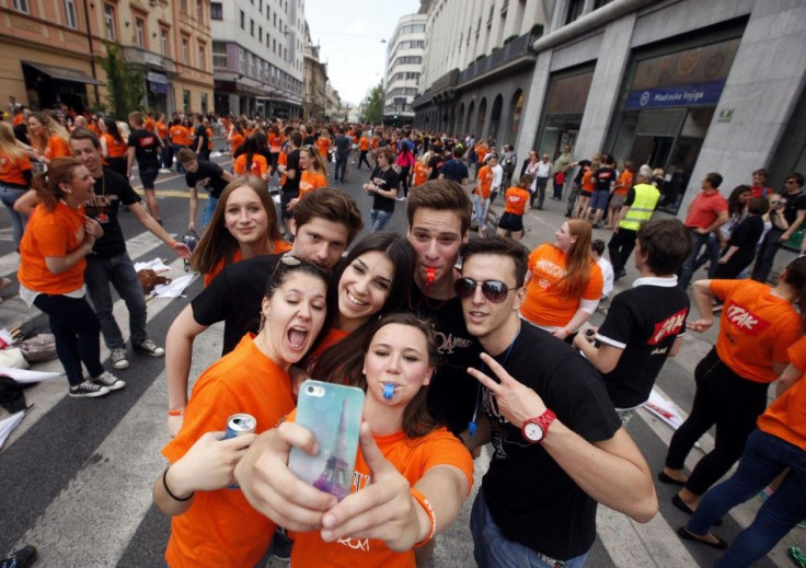 High school graduates take &quot;selfies&quot; on a mobile phone.