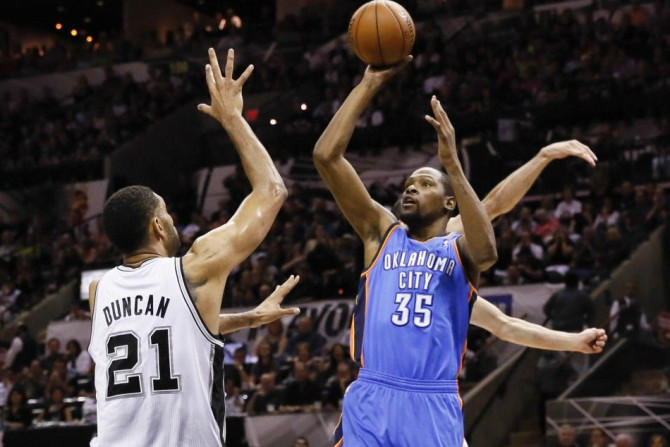 May 29, 2014; San Antonio, TX, USA; Oklahoma City Thunder forward Kevin Durant (35) shoots over San Antonio Spurs forward Tim Duncan (21) during the first half in game five of the Western Conference Finals of the 2014 NBA Playoffs at AT&T Center. 
