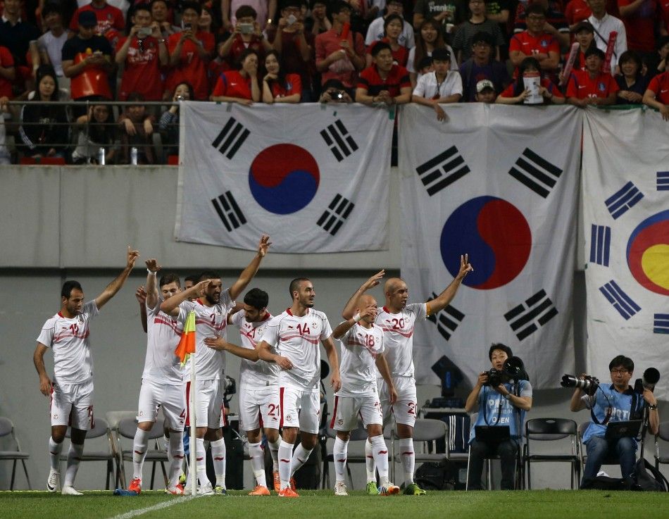 Tunisias Zouhaier Dhaouadi L celebrates with his teammates after scoring a goal against South Korea