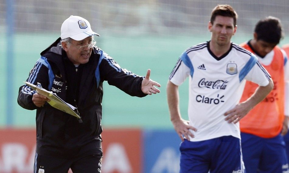 Argentinas national soccer team head coach Alejandro Sabella L gives instructions next to player Lionel Messi