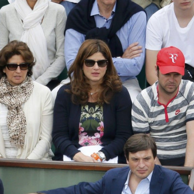 Mirka Federer (C), wife of Roger Federer of Switzerland, watches her husband competing in a men's singles match against Dmitry Tursunov of Russia at the French Open tennis tournament at the Roland Garros stadium in Paris May 30, 2014. 