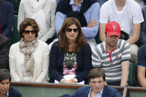 Mirka Federer (C), wife of Roger Federer of Switzerland, watches her husband competing in a men's singles match against Dmitry Tursunov of Russia at the French Open tennis tournament at the Roland Garros stadium in Paris May 30, 2014. 