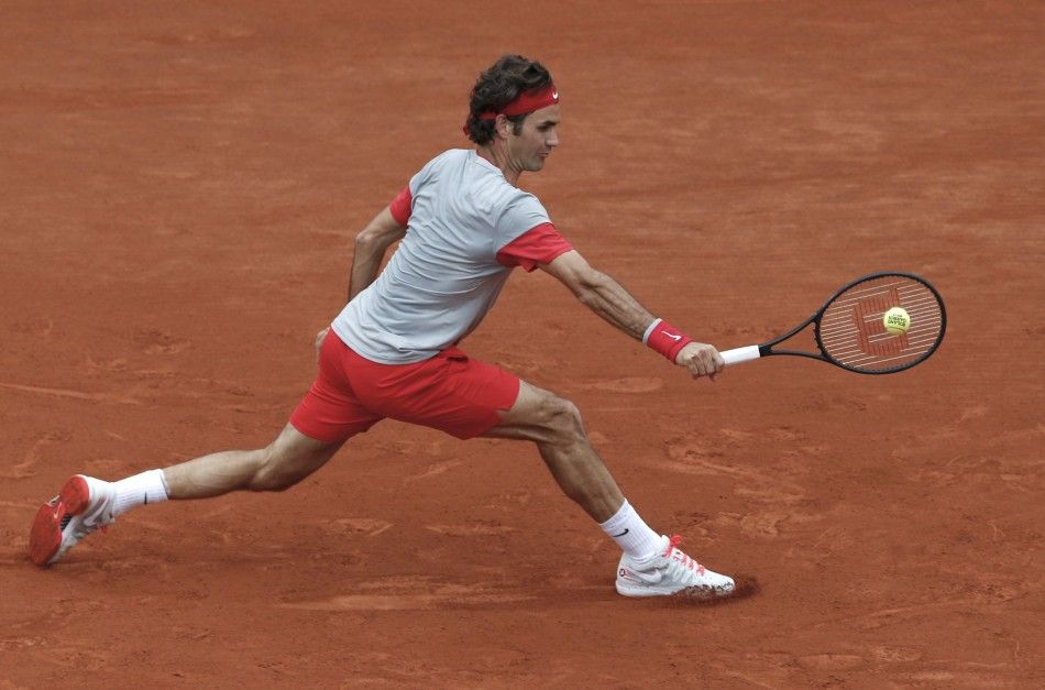 Roger Federer of Switzerland returns a backhand to Ernests Gulbis of Latvia during their mens singles match at the French Open tennis tournament at the Roland Garros stadium in Paris June 1, 2014. 