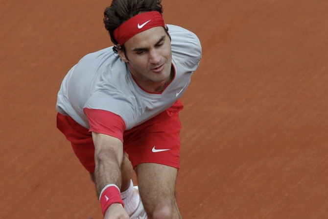Roger Federer of Switzerland returns the ball to Ernests Gulbis of Latvia during their men's singles match at the French Open tennis tournament at the Roland Garros stadium in Paris June 1, 2014.