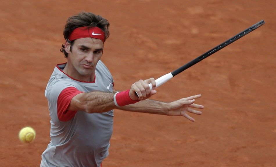 Roger Federer of Switzerland prepares to return the ball to Ernests Gulbis of Latvia during their mens singles match at the French Open tennis tournament at the Roland Garros stadium in Paris June 1, 2014. 