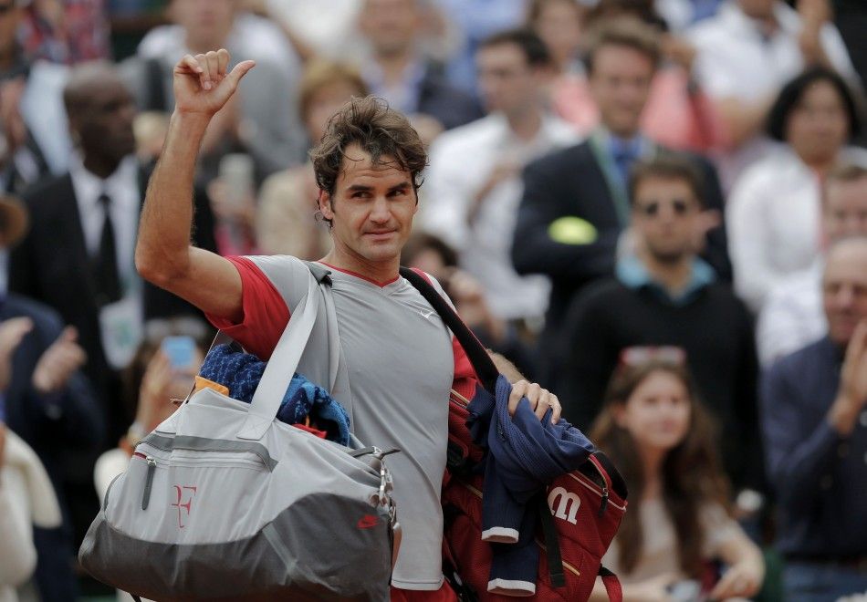Roger Federer of Switzerland leaves the court after being defeated by Ernests Gulbis of Latvia in their mens singles match at the French Open tennis tournament at the Roland Garros stadium in Paris June 1, 2014.