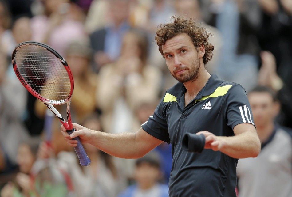 Ernests Gulbis of Latvia reacts after winning his mens singles match against Roger Federer of Switzerland at the French Open tennis tournament at the Roland Garros stadium in Paris June 1, 2014. 