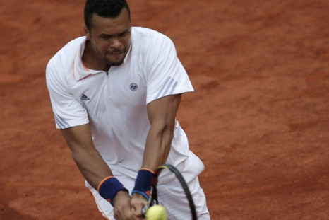 Jo-Wilfried Tsonga of France returns a backhand to Novak Djokovic of Serbia during their men's singles match at the French Open tennis tournament at the Roland Garros stadium in Paris June 1, 2014. 