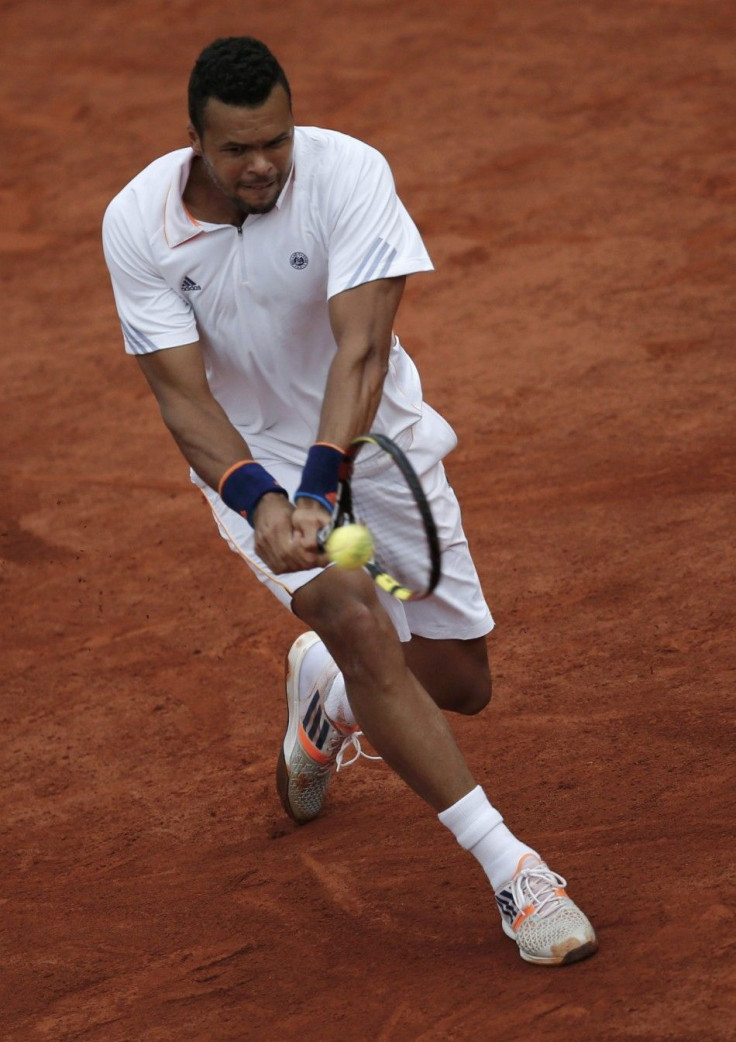 Jo-Wilfried Tsonga of France returns a backhand to Novak Djokovic of Serbia during their men's singles match at the French Open tennis tournament at the Roland Garros stadium in Paris June 1, 2014. 