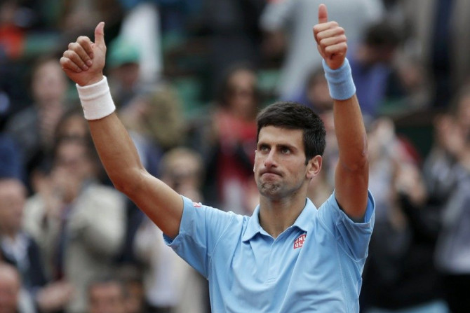 Novak Djokovic of Serbia celebrates after winning his men's singles match against Jo-Wilfried Tsonga of France at the French Open tennis tournament at the Roland Garros stadium in Paris June 1, 2014. 