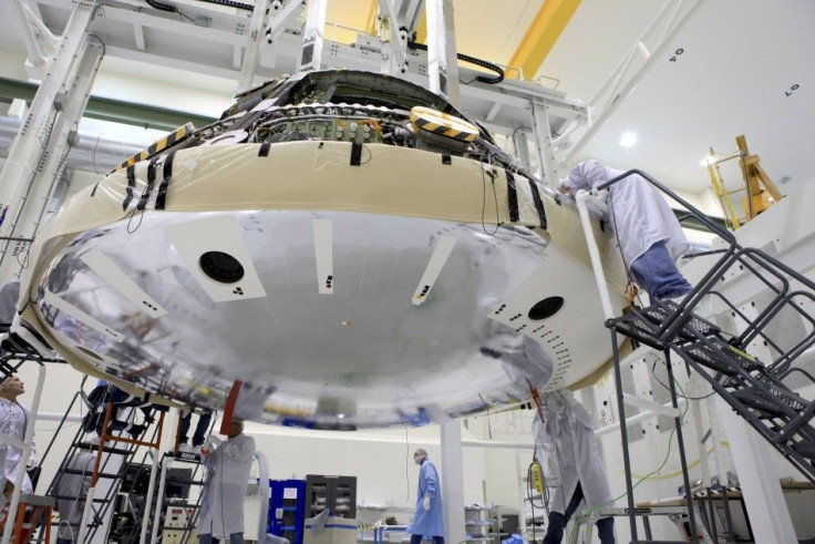 Handout of technicians working on the heat shield of NASA&#039;s Orion space capsule at Kennedy Space Center in Florida