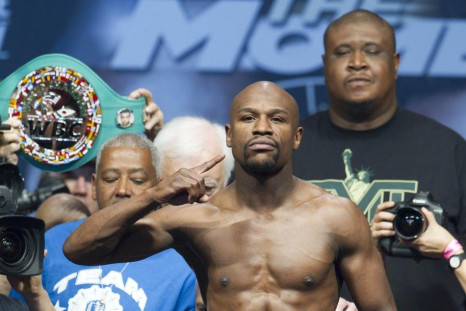 WBC welterweight champion Floyd Mayweather Jr. of the U.S. poses on the scale during an official weigh-in at the MGM Grand Garden Arena in Las Vegas, Nevada, May 2, 2014. Mayweather faces WBA welterweight champion Marcos Maidana of Argentina in a WBC/WBA 