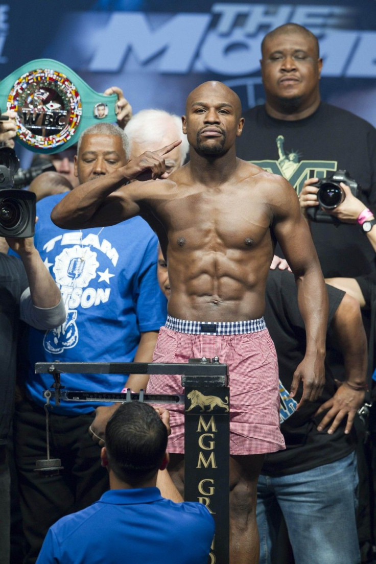WBC welterweight champion Floyd Mayweather Jr. of the U.S. poses on the scale during an official weigh-in at the MGM Grand Garden Arena in Las Vegas, Nevada, May 2, 2014. Mayweather faces WBA welterweight champion Marcos Maidana of Argentina in a WBC/WBA 