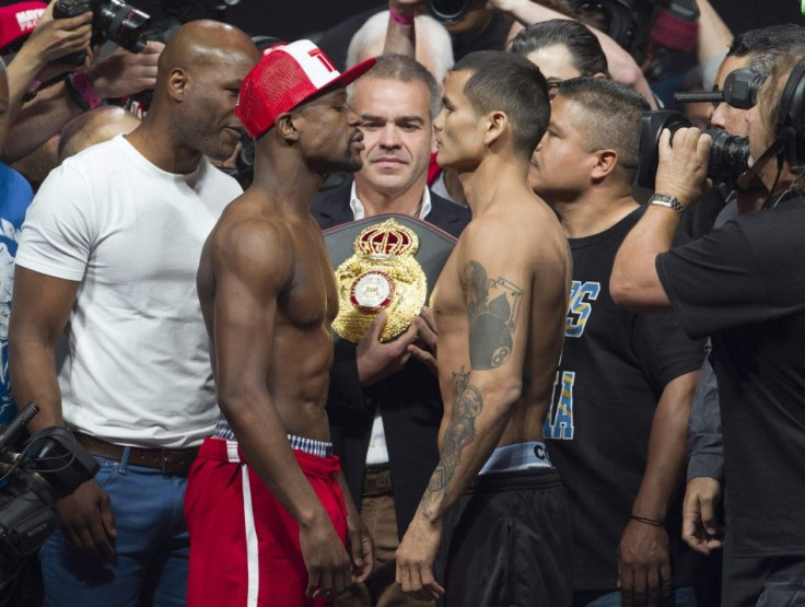 World Boxing Council (WBC) welterweight champion Floyd Mayweather Jr. (L) of the U.S. and World Boxing Association (WBA) champion Marcos Maidana of Argentina face off during an official weigh-in at the MGM Grand Garden Arena in Las Vegas, Nevada, May 2, 2