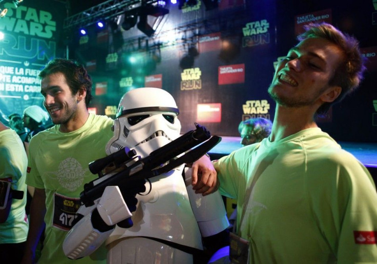 Runners pose with a man dressed as a stormtrooper from the Star Wars movies before the Star Wars Run race ahead of Star Wars Day in Buenos Aires