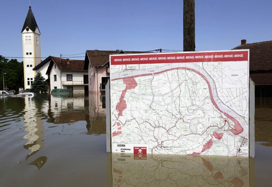 A map showing a land mine field is seen in the water during heavy floods in the village of Prud May 20, 2014. Communities in Serbia and Bosnia battled to protect towns and power plants on Monday from rising flood waters and landslides that have devastated