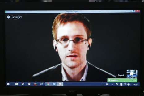 Accused government whistleblower Edward Snowden is seen on a screen as he speaks via video conference