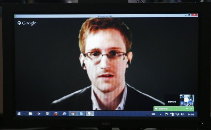 Accused government whistleblower Edward Snowden is seen on a screen as he speaks via video conference