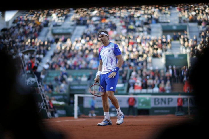 David Ferrer of Spain reacts during his men's quarter-final match against his compatriot Rafael Nadal at the French Open tennis tournament at the Roland Garros stadium in Paris June 4, 2014. 