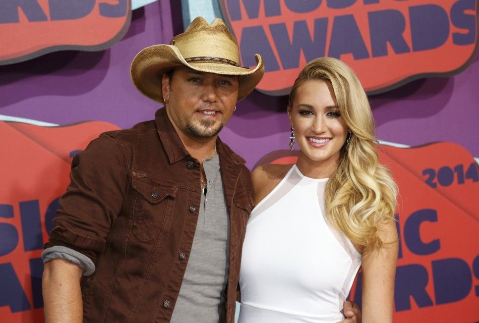 Musician Jason Aldean and guest arrive at the 2014 CMT Music Awards in Nashville