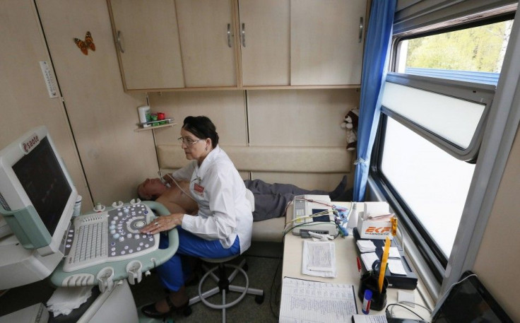 A doctor assists a patient inside the Doctor Voino-Yasenetsky Saint Luka train, which serves as a free consultative and diagnostic medical centre, at a railway station of Divnogorsk, outside Russia's Siberian city of Krasnoyarsk May 26, 2014. The train tr