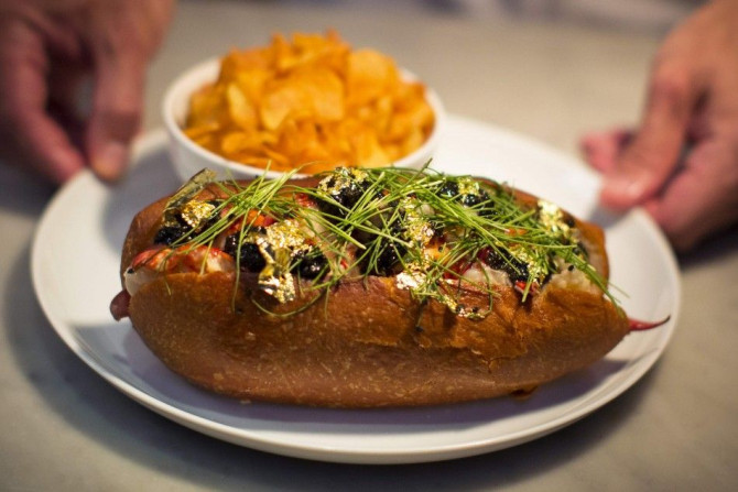 Chef Luke Venner presents a gold and caviar-enriched lobster roll that sells for $160 at &quot;BLT Fish&quot; resturant in New York