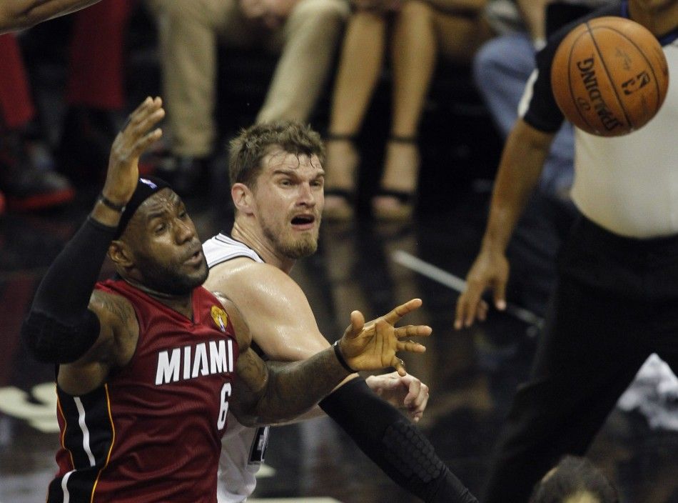 San Antonio Spurs Tiago Splitter R of Brazil knocks the ball out of the hand of Miami Heats LeBron James during the first quarter in Game 1 of their NBA Finals basketball series in San Antonio, Texas June 5, 2014. 