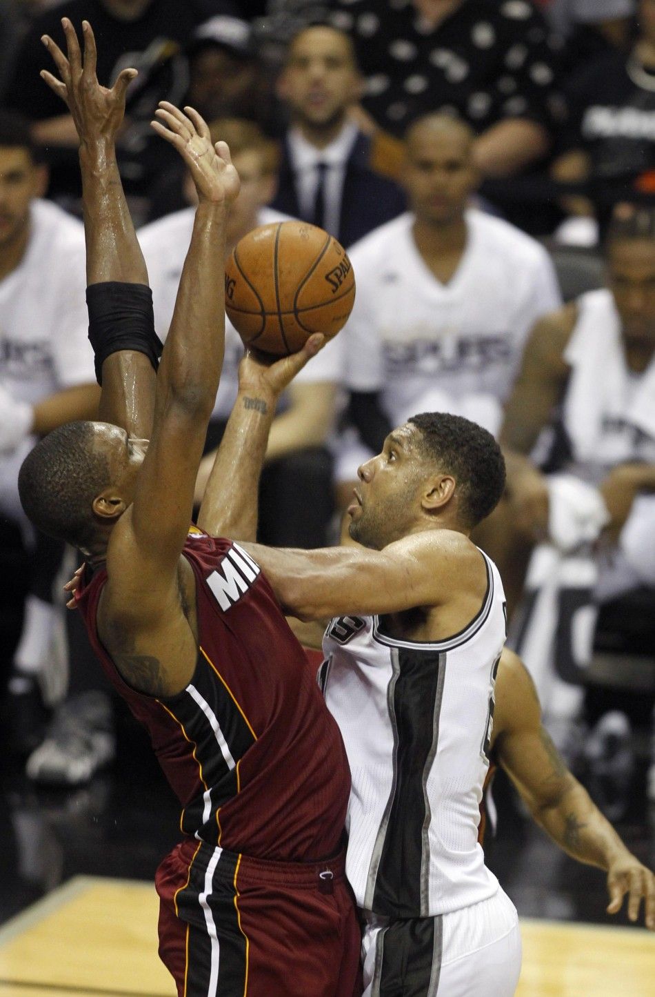 San Antonio Spurs Tim Duncan R muscles to the basket against Miami Heats Chris Bosh during the second quarter in Game 1 of their NBA Finals basketball series in San Antonio, Texas June 5, 2014. 