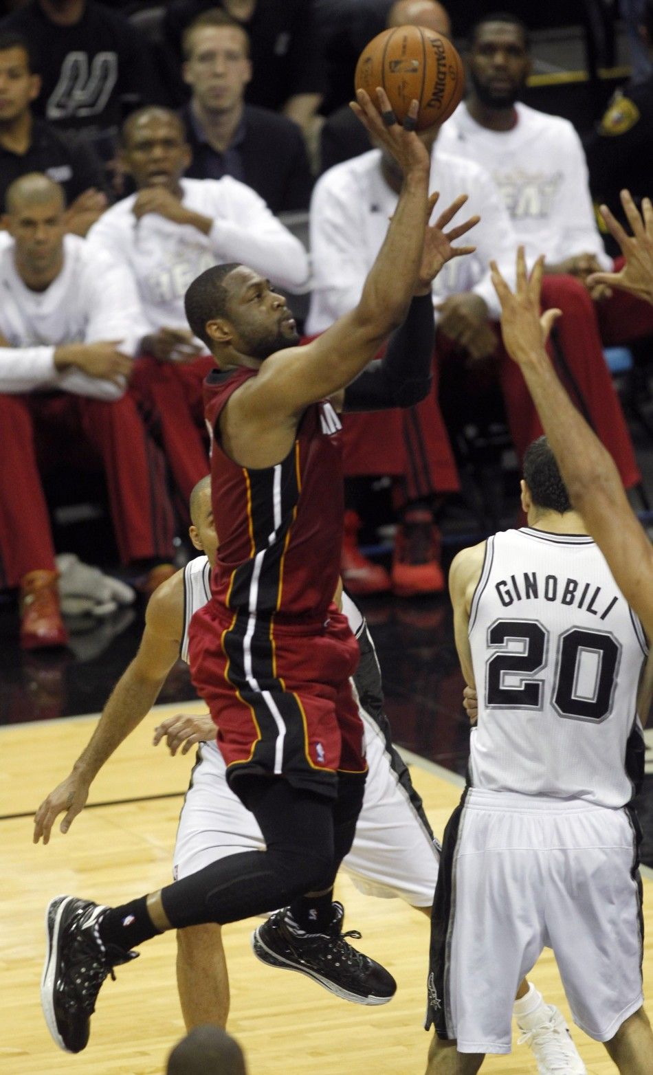 Miami Heats Dwyane Wade L goes up to shoot over San Antonio Spurs Manu Ginobili during the first quarter in Game 1 of their NBA Finals basketball series in San Antonio, Texas June 5, 2014. 