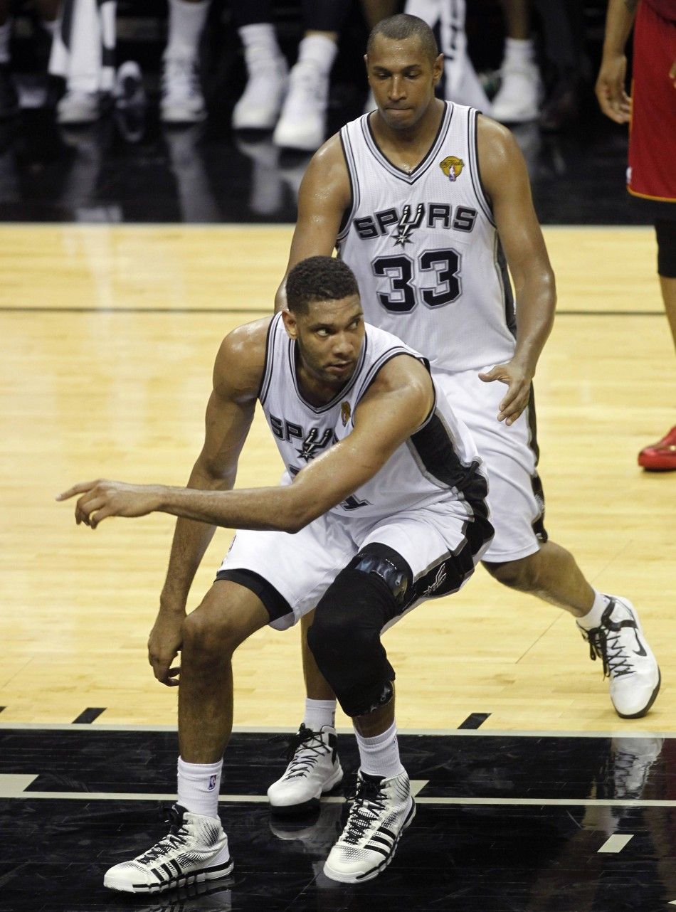 San Antonio Spurs Tim Duncan front reacts after being fouled by Miami Heats Dwyane Wade not pictured as the Spurs Boris Diaw of France looks on in Game 1 of their NBA Finals basketball series in San Antonio, Texas June 5, 2014. 
