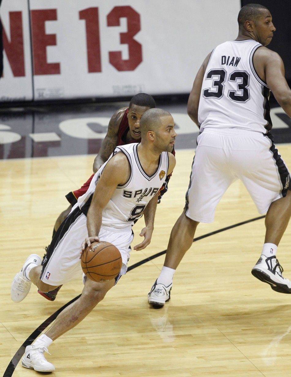 San Antonio Spurs Boris Diaw R of France sets a screen for compatriot Tony Parker C to run around as Miami Heats Mario Chalmers defends during the third quarter in Game 1 of their NBA Finals basketball series in San Antonio, Texas June 5, 2014. 