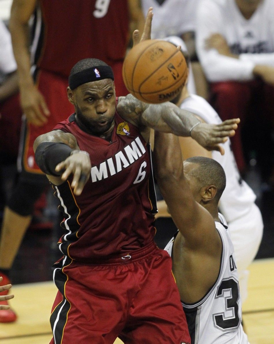 Miami Heats LeBron James L passes over San Antonio Spurs Boris Diaw of France during the second quarter in Game 1 of their NBA Finals basketball series in San Antonio, Texas June 5, 2014. 