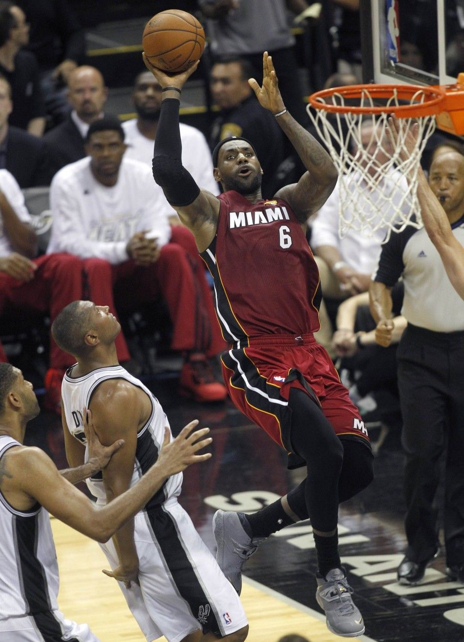 Miami Heats LeBron James R goes up to score past San Antonio Spurs Boris Diaw C of France and Tim Duncan during the second quarter in Game 1 of their NBA Finals basketball series in San Antonio, Texas June 5, 2014. 
