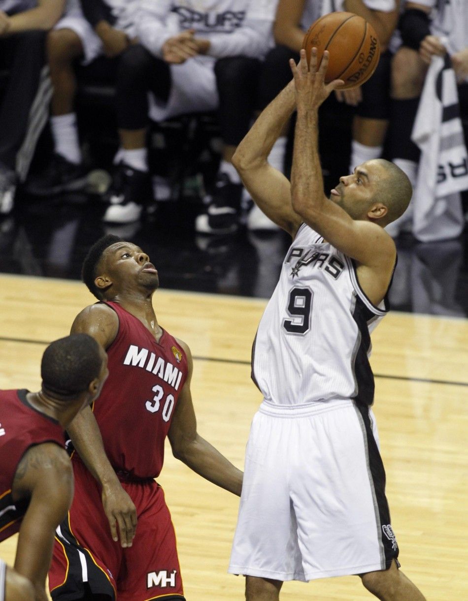 San Antonio Spurs Tony Parker R of France shoots over Miami Heats Norris Cole C and Chris Bosh during the second quarter in Game 1 of their NBA Finals basketball series in San Antonio, Texas June 5, 2014. 
