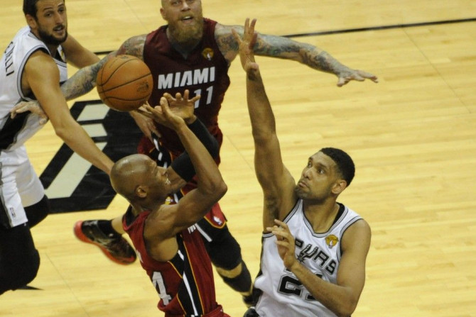 Jun 5, 2014; San Antonio, TX, USA; San Antonio Spurs forward Tim Duncan (21) defends in the first half against Miami Heat guard Ray Allen (34) in game one of the 2014 NBA Finals at AT&T Center.