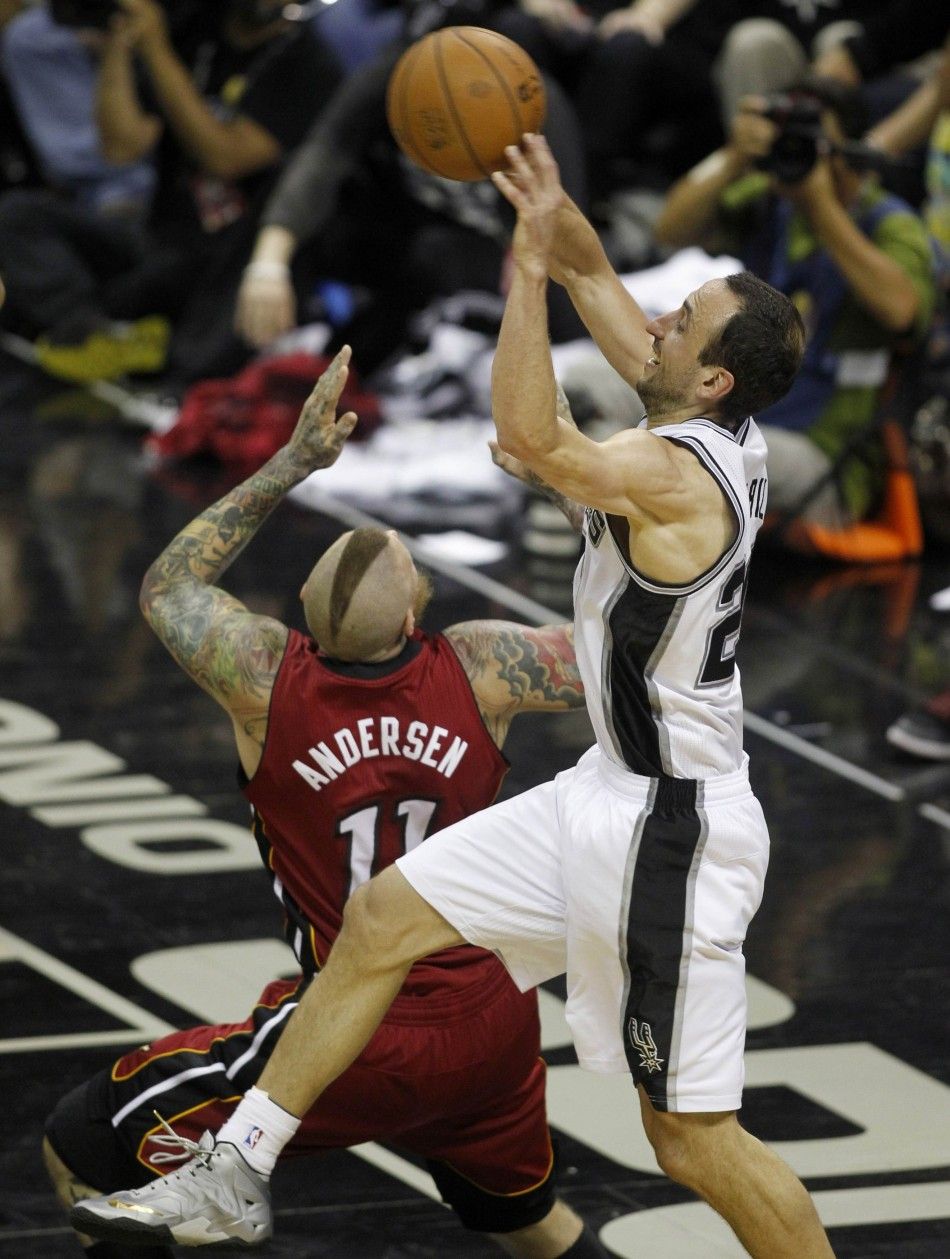 San Antonio Spurs Manu Ginobili R of Argentina fights for a rebound with Miami Heats Chris Andersen during the third quarter in Game 1 of their NBA Finals basketball series in San Antonio, Texas June 5, 2014. 