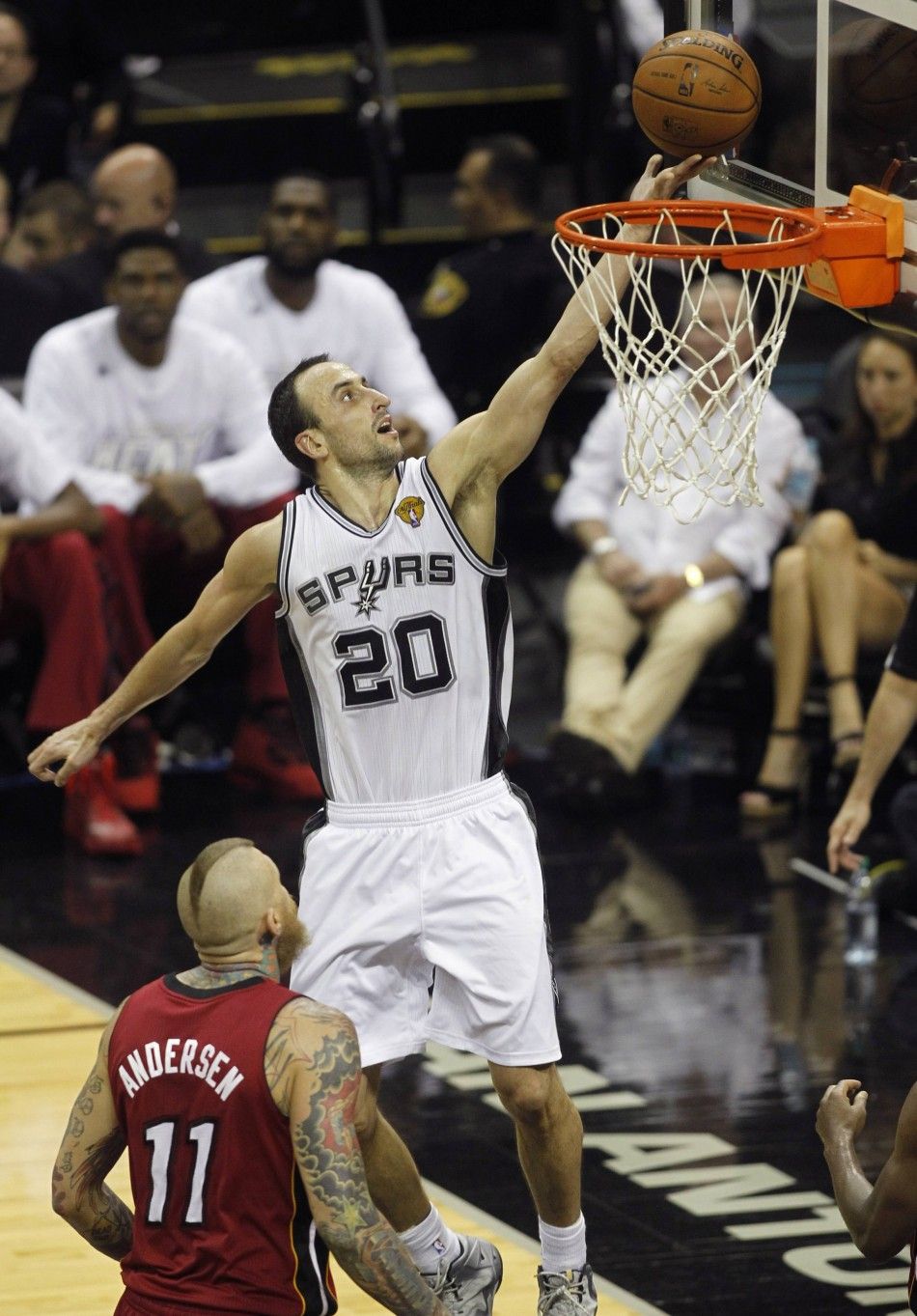 San Antonio Spurs Manu Ginobili R of Argentina goes up to score against Miami Heats Chris Andersen during the third quarter in Game 1 of their NBA Finals basketball series in San Antonio, Texas June 5, 2014. 
