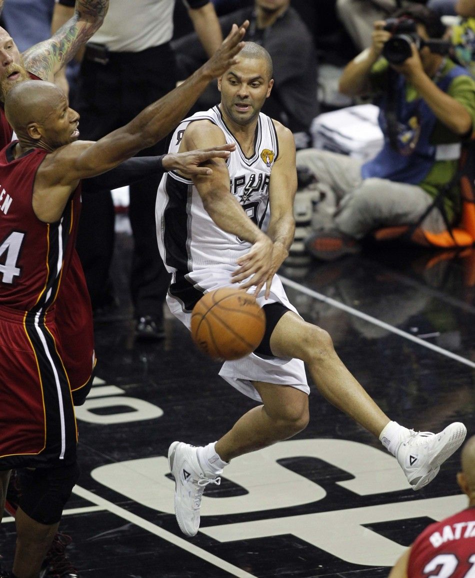 San Antonio Spurs Tony Parker R of France dishes off past Miami Heats Ray Allen during the second half in Game 1 of their NBA Finals basketball series in San Antonio, Texas June 5, 2014. 