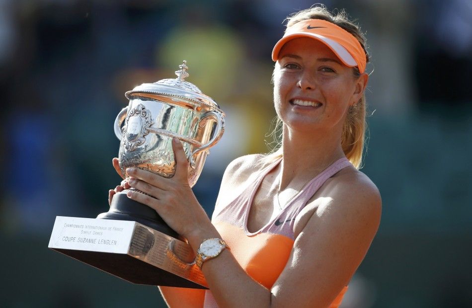 Maria Sharapova of Russia poses with the trophy during the ceremony after defeating Simona Halep of Romania during their womens singles final match to win the French Open tennis tournament at the Roland Garros stadium in Paris June 7, 2014. 