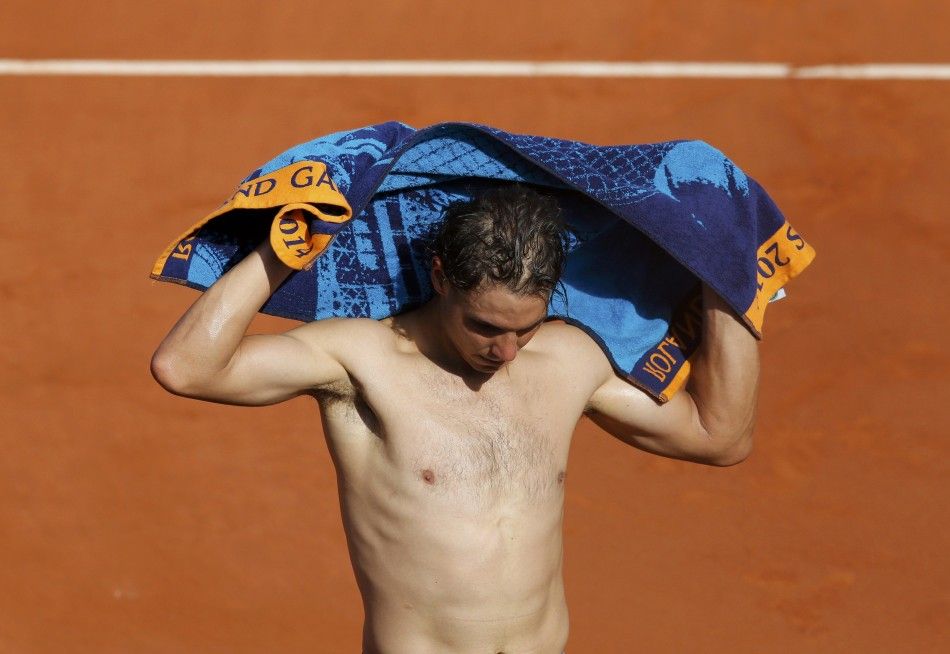 Rafael Nadal of Spain wipes his body with a towel after winning his men039s semi-final match against Andy Murray of Britain at the French Open tennis tournament at the Roland Garros stadium in Paris June 6, 2014.