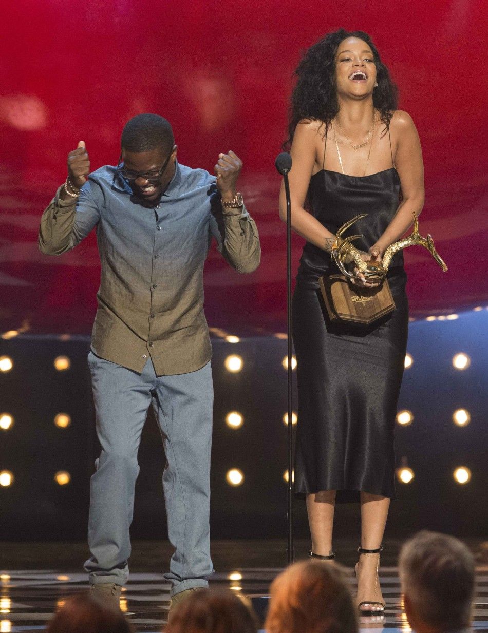 Singer Rihanna Accepts the Most Desirable Woman Award, as Actor Hart Stands Nearby, at the Eighth Annual Spike TVs Guys Choice Awards in Culver City