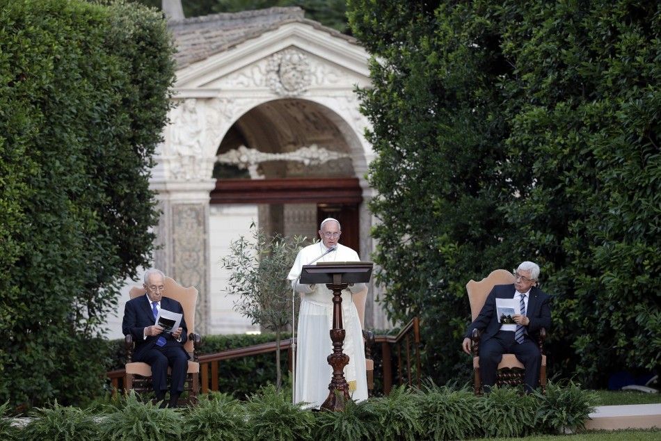  Pope Francis speaks as he is flanked by Israeli President Shimon Peres L and Palestinian President Mahmoud Abbas R in the Vatican Gardens at the Vatican June 8, 2014. REUTERSMax Rossi