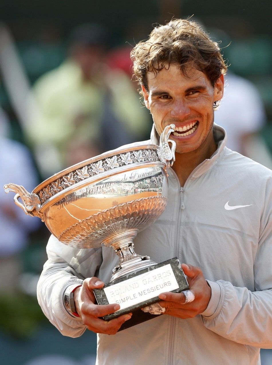 Rafael Nadal of Spain bites the trophy