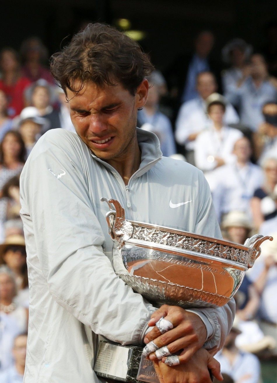 Rafael Nadal of Spain cries as he attends the trophy ceremony 