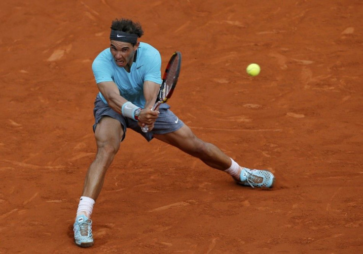 Rafael Nadal of Spain returns the ball to Novak Djokovic of Serbia during their men's singles final match at the French Open Tennis tournament at the Roland Garros stadium in Paris June 8, 2014. 