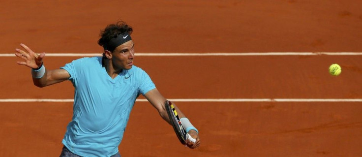 Rafael Nadal of Spain returns the ball to Novak Djokovic of Serbia during their men's singles final match at the French Open Tennis tournament at the Roland Garros stadium in Paris June 8, 2014. 